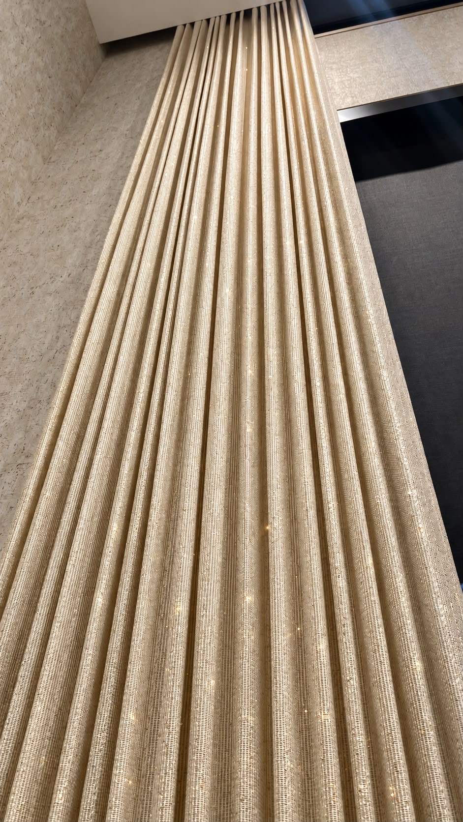 Close-up of textured ivory drapery fabric with soft folds
